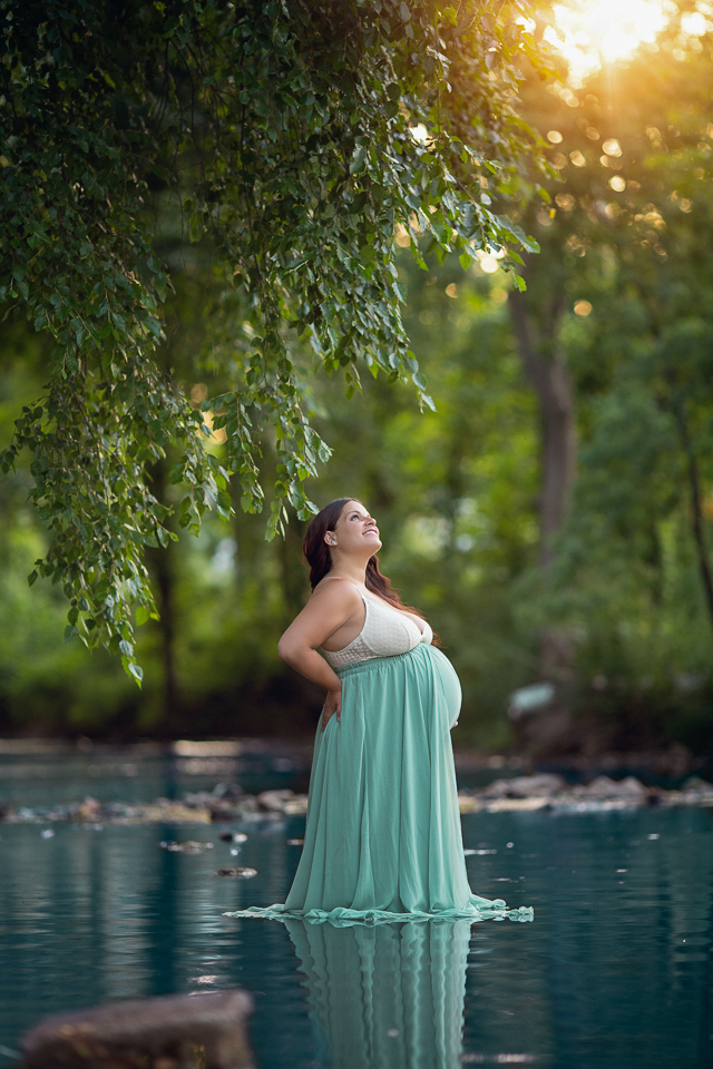 Expecting mother to be in a river posing for maternity photos