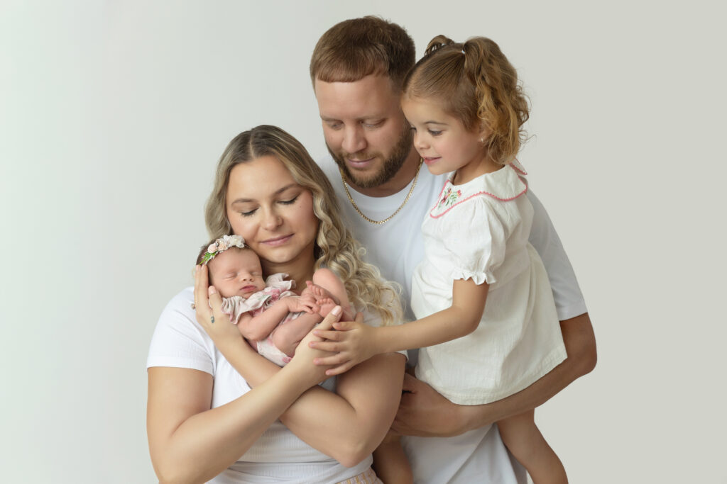 parents holding newborn during Central NJ newborn photography session